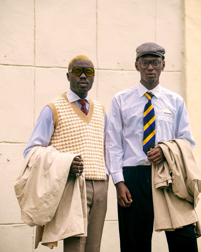 bedroom-bliss Two men pose in vintage style attire, showcasing retro fashion with unique accessories.