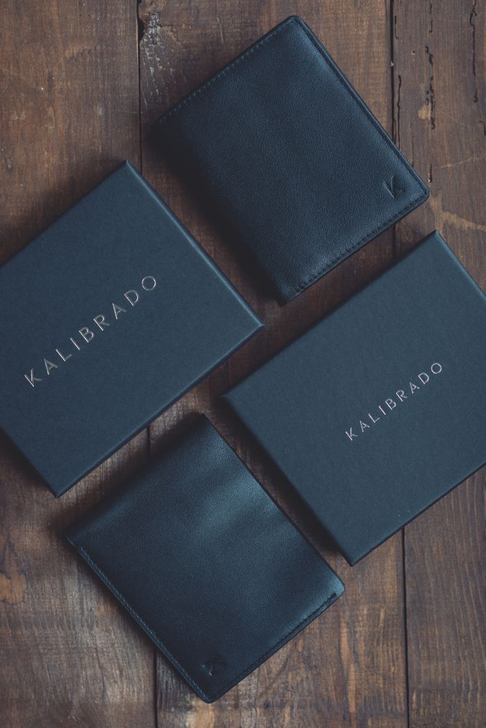 collection-04 Stylish black leather wallets displayed on a rustic wooden surface, perfect for fashion and lifestyle themes.